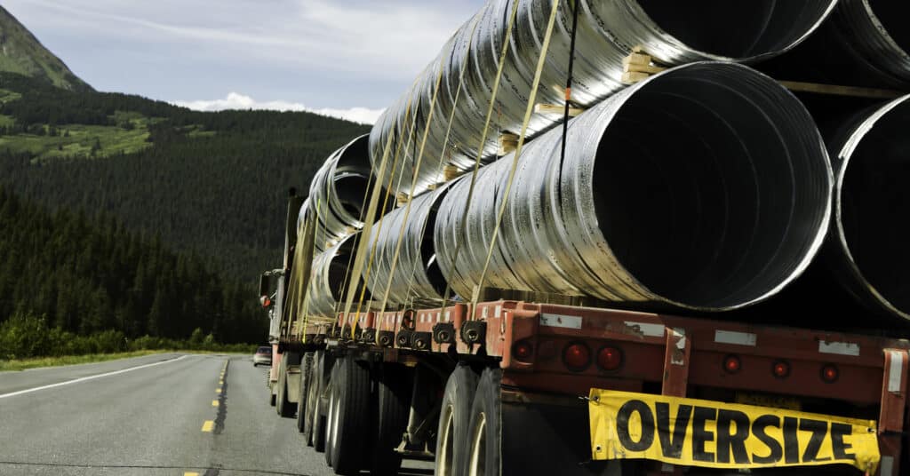 Oversize trailer with big metal tubes