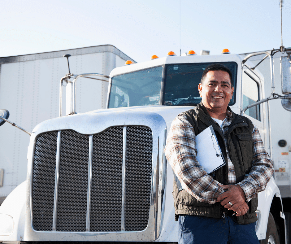 Truck driver with clipboard by semi truck